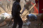 A police officer beats a student protester in Letpadan, 140 kilometers (90 miles) north of Yangon, Myanmar, Tuesday March 10, 2015.