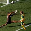 Brett Holman, right, scores a goal past Ghana goalkeeper Richard Kingson