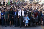 President Barack Obama, center, walks as he holds hands with Amelia Boynton Robinson, who was beaten during "Bloody Sunday," as they and the first family and others including Rep. John Lewis, D-Ga,, left of Obama, walk across the Edmund Pettus Bridge in Selma, Ala. for the 50th anniversary of “Bloody Sunday," a landmark event of the civil rights movement, Saturday, March 7, 2015.