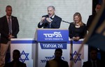 Israeli Prime Minister Benjamin Netanyahu greets supporters at the party's election headquarters In Tel Aviv. Wednesday, March 18, 2015.