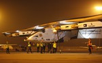 Crew members gather to push the Solar Impulse 2 towards a hangar after it landed at an airport in Ahmadabad, India, Wednesday, March 11, 2015.