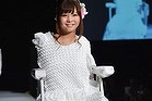 Poet Ami Sano, born without arms and only one partially formed foot, models Tenbo's wedding dress.