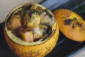 Roast umami vegetables with orange miso in an orange pot.