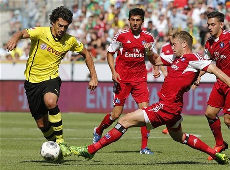 Dortmund's Mats Hummels, left, and Hamburg's Lasse Sobiech challenge for the ball during the Telekom Cup soccer match between HSV Hamburg and BvB Borussia Dortmund in Moenchengladbach, Germany, Sunday, July 21, 2013.