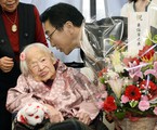 Japan's Misao Okawa, 116, who is recognized as the world's oldest living person by Guinness World Records is celebrated by Ward Mayor Takehiro Ogura at a nursing home in Osaka, western Japan Wednesday, March 4, 2015 ahead of her birthday.