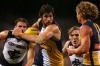 Josh Kennedy of the Eagles muscles his way past Blues players during Friday's game at Domain Stadium.