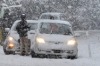 A tractor clears snow on State Highway 94 south of Te Anau as stranded tourists wait for the road to be cleared during heavy morning snow on state Highway 94.