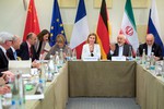 U.S. Secretary of State John Kerry sits with fellow Foreign Ministers and Political Directors from the European Union, P5+1 nations - the United Kingdom, Germany, France, Russia, and China, as well as Iranian Foreign Minister Javad Zarif and his advisers on April 2, 2015, in Lausanne, Switzerland, following negotiations about the future of their country’s nuclear program.