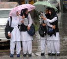 File - School girls with umbrellas during heavy rain in Srinagar, Kashmir, India, 3 September 2014.