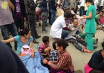 An injured man receives treatment outside the Medicare Hospital in Kathmandu, Nepal, Saturday, April 25, 2015.