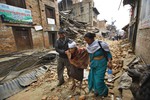 An elderly injured woman is taken to her home after treatment in Bhaktapur near Kathmandu, Nepal, Sunday, April 26, 2015, following a deadly earthquake.