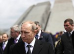 Russian President Vladimir Putin walks during a memorial service at the Tsitsernakaberd Genocide memorial complex in Yerevan, Armenia, Friday, April 24, 2015.