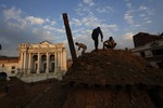 Nepalese students and volunteers clear the rubble at Kathmandu Durbar Square, a UNESCO World Heritage Site, in Kathmandu, Nepal, Wednesday, April 29, 2015, following a devastating 7.8 magnitude earthquake that shook the region.