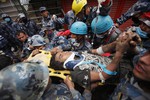 A Nepalese man being rushed to hospital on a strecher after being rescued by Nepalese policemen and US rescue workers alive from the debris of a building after five days, in Kathmandu, Nepal ,Thursday, April 30, 2015.