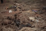 In this photo taken Wednesday, April 8, 2015, decomposed bodies of civilians reportedly killed by Boko Haram lie around on the ground in Gwoza, Nigeria.