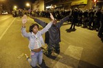 Protesters demonstrate ahead of a 10 p.m. curfew Wednesday, April 29, 2015, in Baltimore. The curfew was imposed after unrest in Baltimore over the death of Freddie Gray while in police custody.