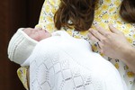 Britain's Prince William and Kate, Duchess of Cambridge, hold their newborn daughter as they as they pose for the media outside St. Mary's Hospital's exclusive Lindo Wing, London, Saturday, May 2, 2015.