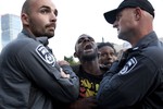 Israeli police officers detain an Israeli Ethiopian during a demonstration in Tel Aviv, Sunday, May 3, 2015.