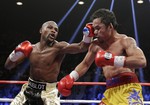 Floyd Mayweather Jr., left, hits Manny Pacquiao, from the Philippines, during their welterweight title fight on Saturday, May 2, 2015 in Las Vegas.