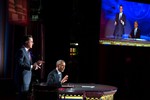 File - President Barack Obama takes over for Stephen Colbert during "The Word" segment of "The Colbert Report with Stephen Colbert" during a taping at George Washington University's Lisner Auditorium in Washington, D.C., Dec. 8, 2014.