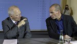 File - German Finance Minister Wolfgang Schaeuble, left, and the Finance Minister of Greece, Yanis Varoufakis, right, talk prior to a joint press conference as part of a meeting in Berlin, Germany, Thursday, Feb. 5, 2015.