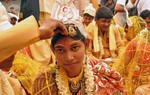 Indian Hindu couples look on as they wait to participate in a community mass marriage ceremony in Kolkata . 51 under-privileged couples mostly from the Sunderbans area participated in the marriage that was organised by a charitable trust at Kolkata in Eastern India City