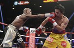 Floyd Mayweather Jr., left, hits Manny Pacquiao, from the Philippines, during their welterweight title fight on Saturday, May 2, 2015 in Las Vegas.