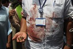 A Pakistani security official displays cartridges he collected from the scene of an attack on a bus, in Karachi, Pakistan, Wednesday, May 13, 2015.