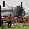 Emergency personnel gather near the scene of a deadly train derailment, Wednesday, May 13, 2015, in Philadelphia.