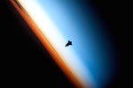 File - The silhouette of the space shuttle Endeavour is pictured as seen from the International Space Station, as the shuttle approached for its docking on Feb. 9, 2010. The orange layer is the troposphere, where all of the weather and clouds which we typically watch and experience are generated and contained. This orange layer gives way to the whitish Stratosphere and then into the Mesosphere.