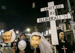 Followers of the Hungarian organization Human Platform hold photos of Putin, left, and Hungarian Prime Minister Viktor Orban as they protest against the visit of Russian President Vladimir Putin in front of Keleti Railway Station in Budapest, Hungary, Monday, Feb. 16, 2015