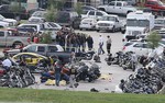 Authorities investigate a shooting in the parking lot of the Twin Peaks restaurant Sunday, May 17, 2015, in Waco, Texas. Authorities say that the shootout victims were members of rival biker gangs that had gathered for a meeting.