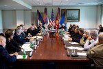 File - President Barack Obama meets with senior military leadership at the Pentagon in Arlington, Virginia, Oct. 8, 2014.