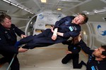 File - Noted physicist Stephen Hawking (center) enjoys zero gravity during a flight aboard a modified Boeing 727 aircraft owned by Zero Gravity Corp. (Zero G), 26 April, 2007.