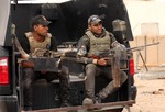 Iraqi anti-terrorism soldiers guard a graduation ceremony of Sunni tribal volunteers joining Iraqi security forces in the town of Amiriyat al-Fallujah, west of Baghdad, Iraq, Friday, May 8, 2015.