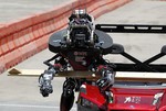 Robot Warner from Worchester Polytechnic Institute drives a vehicle through stage one in the U.S. Defense Advanced Research Projects Agency Robotics challenge in Pomona, Calif., Friday, June 5, 2015.