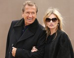 Model Kate Moss and photographer Mario Testino arrive for the Burberry Womenswear Autumn/Winter 2015 show at London Fashion Week in Kensington Gardens, west London, Monday, Feb. 23, 2015.