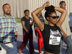 Hundreds march during a protest in response to an incident at a community pool involving McKinney police officers Monday, June 8, 2015, in McKinney, Texas.