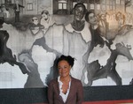 FILE - In this July 24, 2009, file photo, Rachel Dolezal, a leader of the Human Rights Education Institute, stands in front of a mural she painted at the institute's offices in Coeur d'Alene, Idaho.