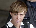 Charleston, S.C., shooting suspect Dylann Storm Roof is escorted from the Cleveland County Courthouse in Shelby, N.C., Thursday, June 18, 2015.