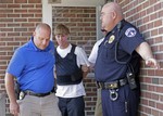 Charleston, S.C., shooting suspect Dylann Storm Roof, center, is escorted from the Shelby Police Department in Shelby, N.C., Thursday, June 18, 2015.