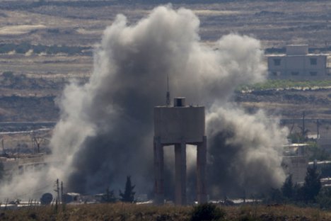 Smoke and explosions from fighting between forces loyal to Syrian President Bashar Assad and rebels in the Quneitra area of Syria are seen from the Israeli-occupied Golan Heights, Wednesday, June 17, 2015.