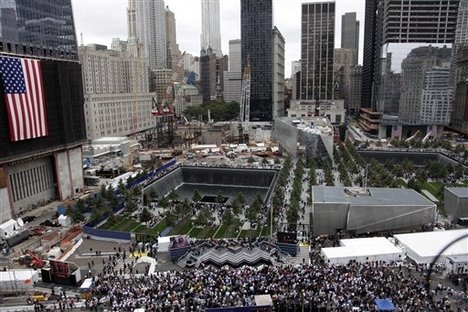 Friends and family members of 9/11 victims visit a September 11 Memorial waterfall during a ceremony marking the 10th anniversary of the attacks, Sunday, Sept. 11, 2011 in New York.