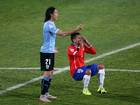 Gonzalo Jara falls down after clashing with Edinson Cavani