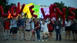 Same-sex marriage supporters hold up balloons that spell the words "love wins" as they stand in front of the White House, which is lit up in rainbow colors in commemoration of the Supreme Court's ruling to legalize same-sex marriage, on Friday, June 26, 2015, in Washington.