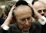 Lord Greville Janner, a member of the British parliament adjusts his scullcap before a jewish prayer outside the Hadassah Hospital in Jerusalem, where Israeli Prime Minister Ariel Sharon is in critical condition, Monday Jan. 9, 2006.