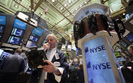 A trader uses a phone post on the floor of the New York Stock Exchange Tuesday, June 30, 2009