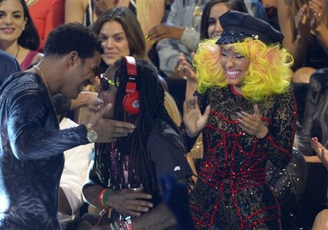 From left, Drake, Lil Wayne and Nicki Minaj react as they are announced the winners of the award for best hip-hop video for "Hyfr" at the MTV Video Music Awards on Thursday, Sept. 6, 2012, in Los Angeles.