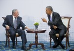 US President Barack Obama, right, leans over towards Cuban President Raul Castro during their meeting at the Summit of the Americas in Panama City, Panama, Saturday, April 11, 2015.