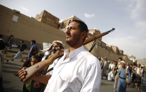 File - A Shiite rebel known as Houthi, holds his weapon during a rally against Saudi-led airstrikes in Sanaa, Yemen, Sunday, June 14, 2015.